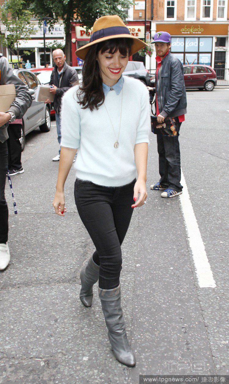 英國女歌手Katie Melua穿著淺藍上衣與灰色靴子，並以紫色繫帶紳士帽做搭配，帶點男孩調皮感的Look，看起來非常討喜。圖／達志影像