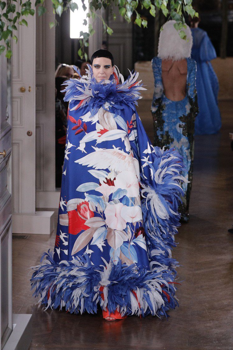罩袍式的設計，在面料上繪製了帶有東方風情的印花，同時搭配相近色羽毛裝飾，凸顯了Valentino這季的民俗風格。圖／美聯社