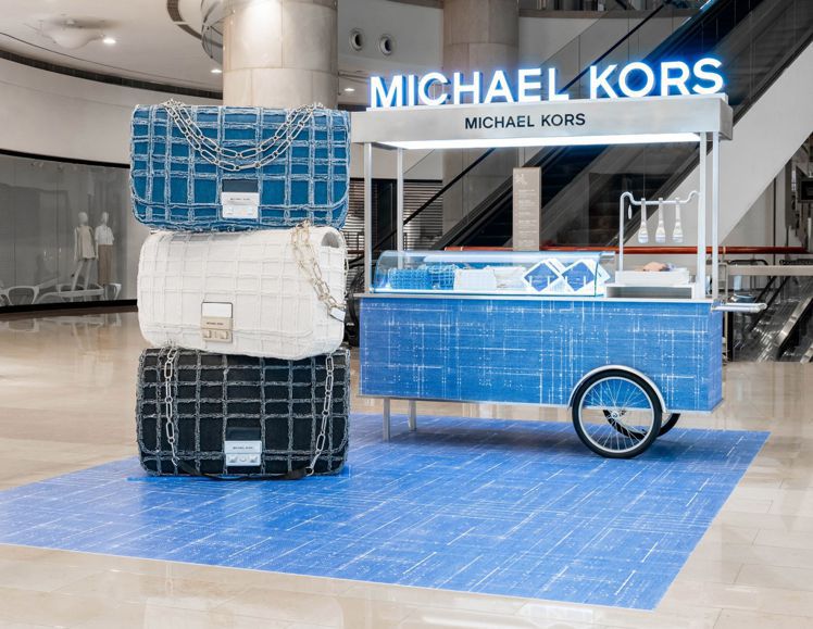 台北101自即日起到5月1日止，呈現Michael Kors丹寧快閃麵包餐車，並每日限定提供只送不賣的蜜糖扁可頌！圖／Michael Kors提供
