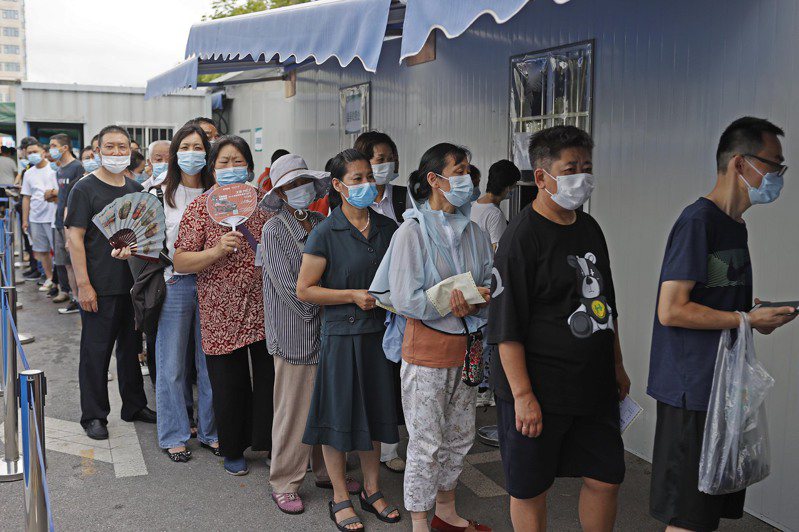 近日大陆多个地方陆续出现本土疫情，上海各核酸检测机构的检测量骤增，经常出现排队等候採样的人潮。（中新社）(photo:UDN)