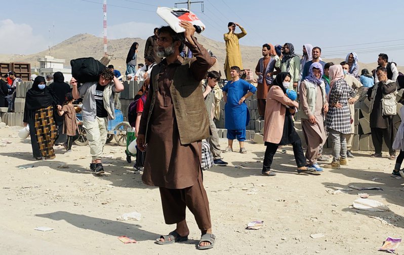 神学士进军阿富汗首都后，大批阿富汗民众涌入喀布尔机场寻求出逃机会。 欧新社(photo:UDN)