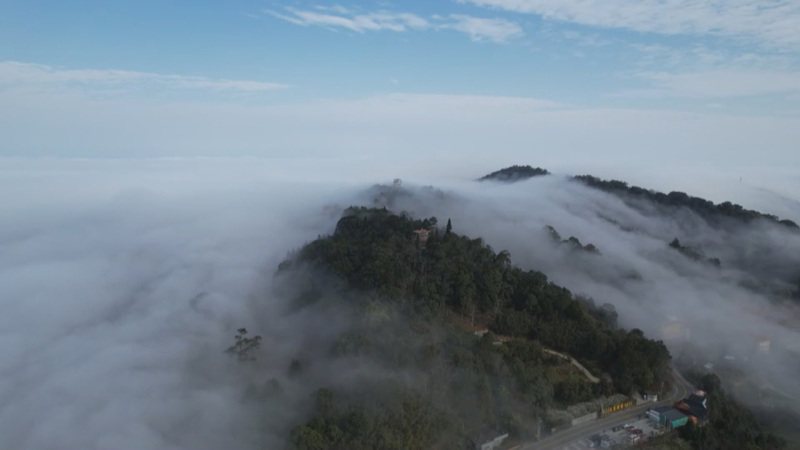 苗栗縣攝影玩家張麥斯透過無人機空中攝影，記錄大湖鄉薑麻園地區，白色雲霧從關刀山稜線沿著山坡飄散，宛如瀑布一般傾洩而下，令人為之驚嘆。（張麥斯提供）