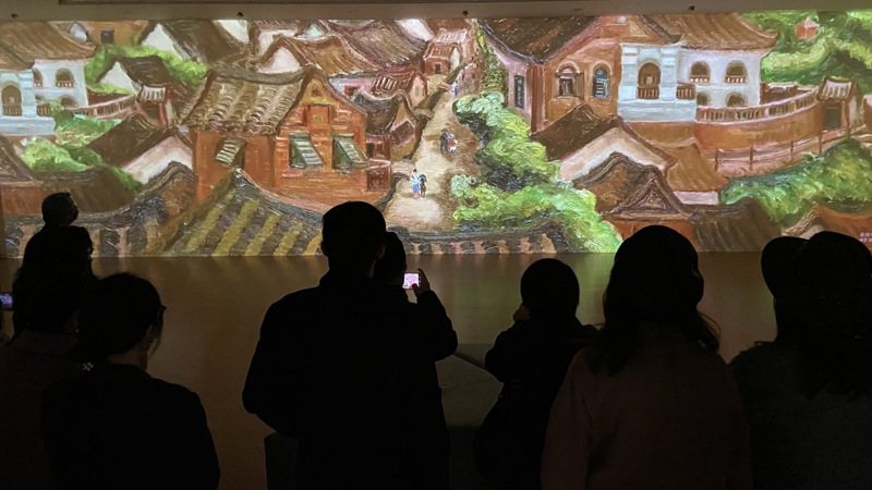亞洲大學現代美術館雙特展今開幕，「望鄉三態」觀眾透過VR體驗，走入郭雪湖的畫中世界，體驗大稻埕繁華。圖／亞洲大學提供