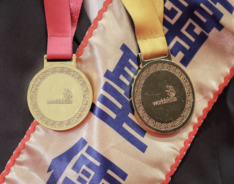 蕭聖儒奪2022國際技能競賽「電氣裝配」職類金牌（右），獲頒國家最優秀選手獎牌（左）。圖／雄工提供