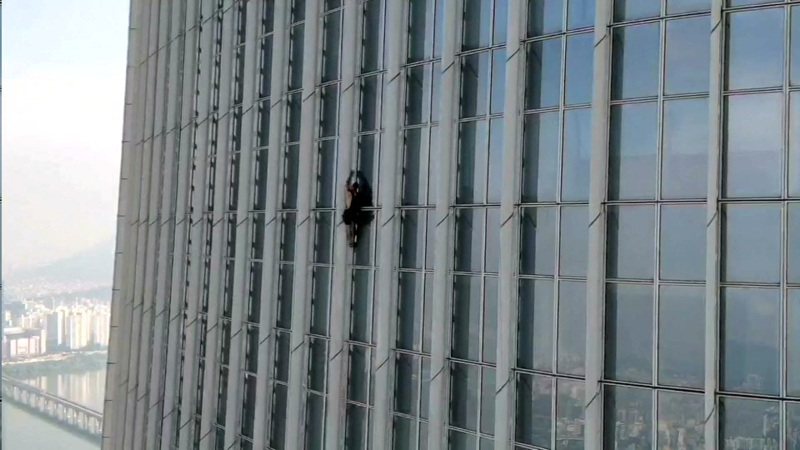 一名英裔男子12日徒手攀登全球第5高的摩天大樓、位於南韓首爾的樂天塔，攀至73樓時在南韓警方要求下放棄繼續攀爬。（路透）
