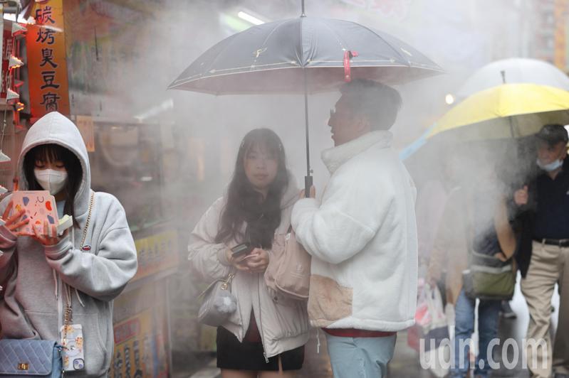 農曆春節假期可說是「先濕冷，後乾冷」的天氣型態。大台北民眾聚在冒煙的攤位前，購買熱食驅寒。記者蘇健忠／攝影