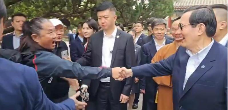 前總統馬英九（右）7日上午參觀大慈恩寺時，遇到熱情的一群台灣遊客高喊「總統好」，馬親切問候並上前握手。（記者廖士鋒／攝影）