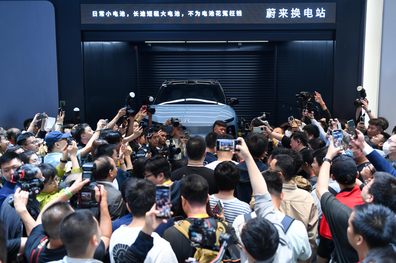 睽违四年，北京车展强势回归，吸引各界目光。图为大批参观者在蔚来汽车展台观看电动汽车换电站演示。（新华社）