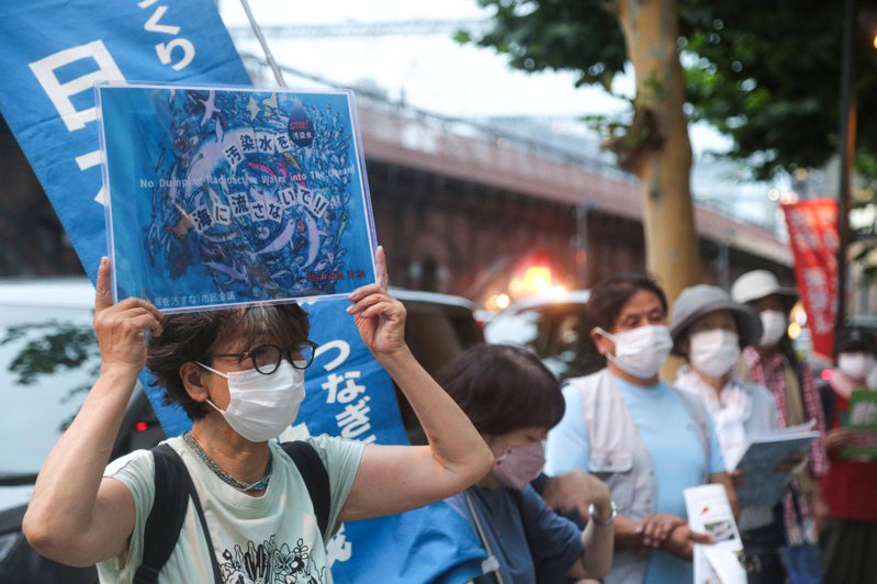 近百名日本民眾5日手持「不要將核汙染水排海」等標語，在福島第一核電站運營方東京電力公司總部前，抗議福島核汙染水排海計畫。（中通社）