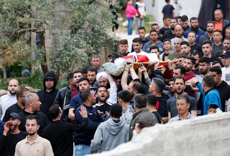 由於以色列的一名少年離奇失蹤死亡，以色列屯懇者圍堵巴勒斯坦城鎮抗議，導致一名巴勒斯坦民眾喪生。圖為巴勒斯坦人抬著遇害者的屍體遊行。(路透)