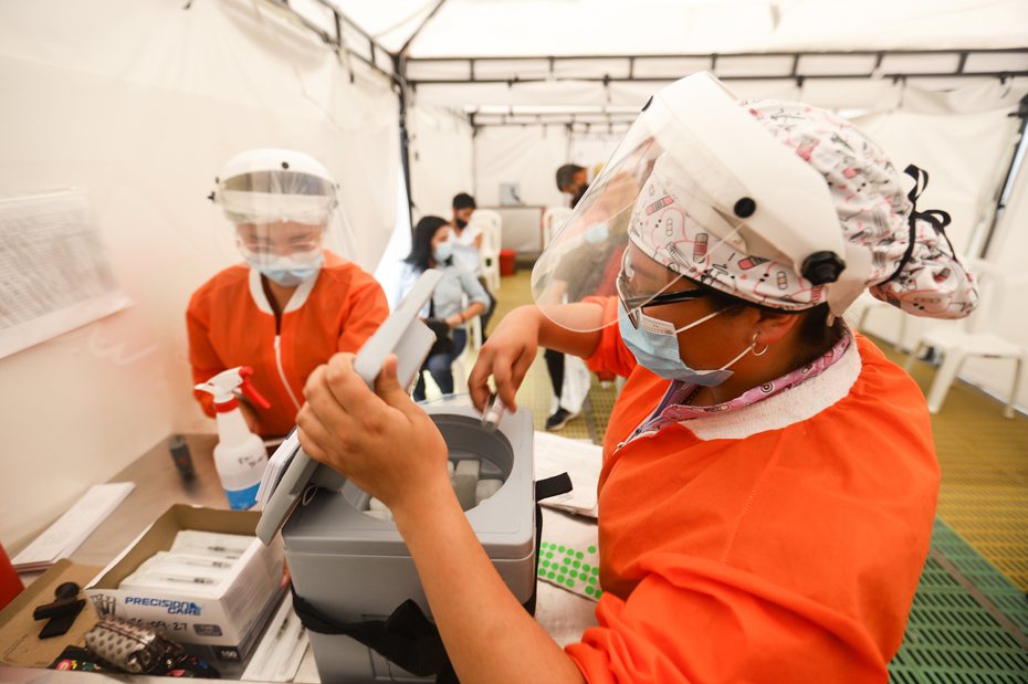 新一批科興疫苗在哥倫比亞分配使用。工作人員在哥倫比亞首都波哥大的黃金廣場購物中心疫苗接種點忙碌。 新華社