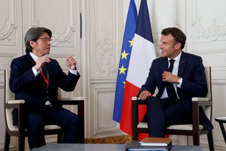 法國總統馬克宏（右）2022年7月11日在「選擇法國」活動上與輝能執行長楊思枏相談甚歡。路透