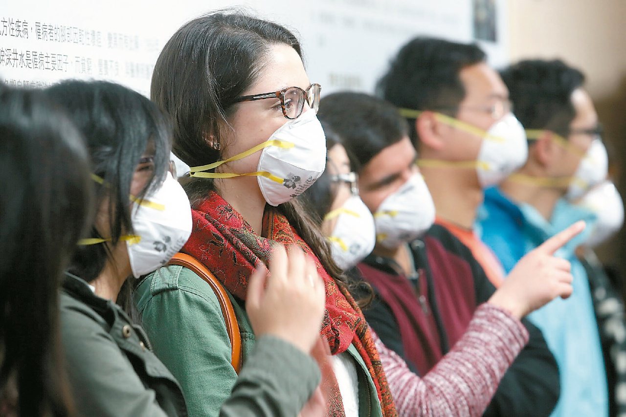 台大公衛學院「從PM2.5看我們的穹頂」記者會中，ㄧ同出席的學生載上N95口罩，表達目前空氣汙染嚴重，會增加心血管疾病的警訊。