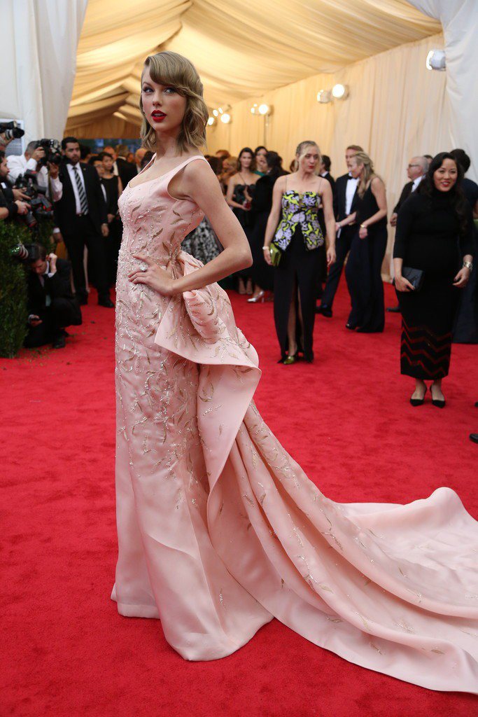 泰勒絲的 Oscar de la Renta 粉紅色金線刺繡禮服貴氣優雅，長裙擺和背後繁複設計吻合主題。圖／擷取自nytimes.com