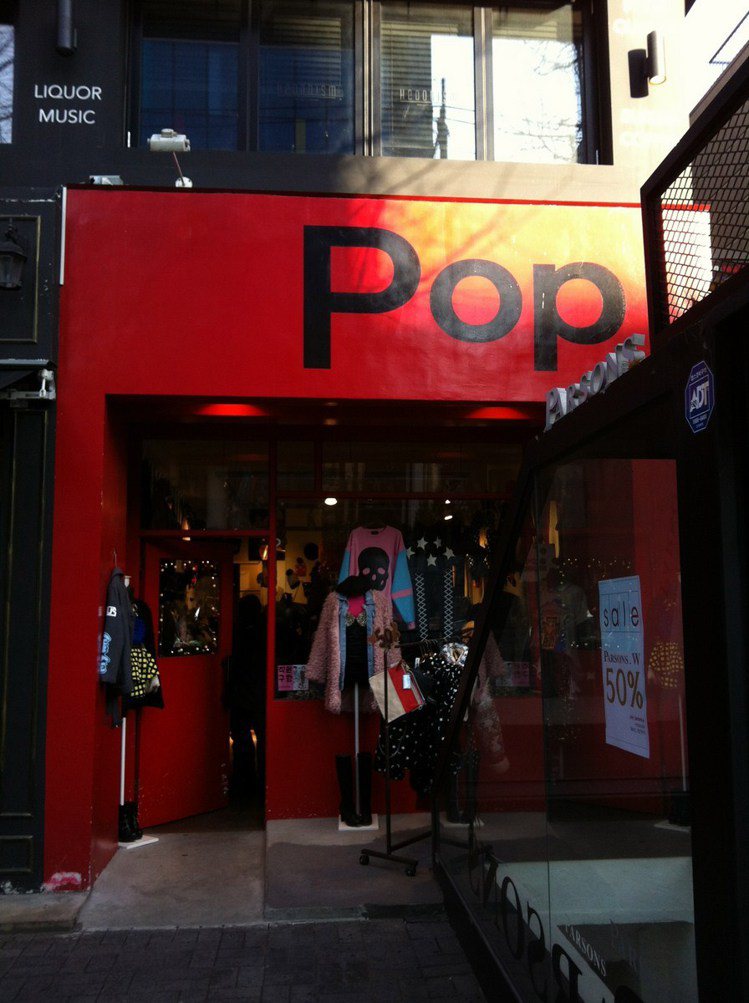 鮮紅色大門配上黑色顯眼的POP招牌，充分顯露品牌個性。圖／時報出版提供