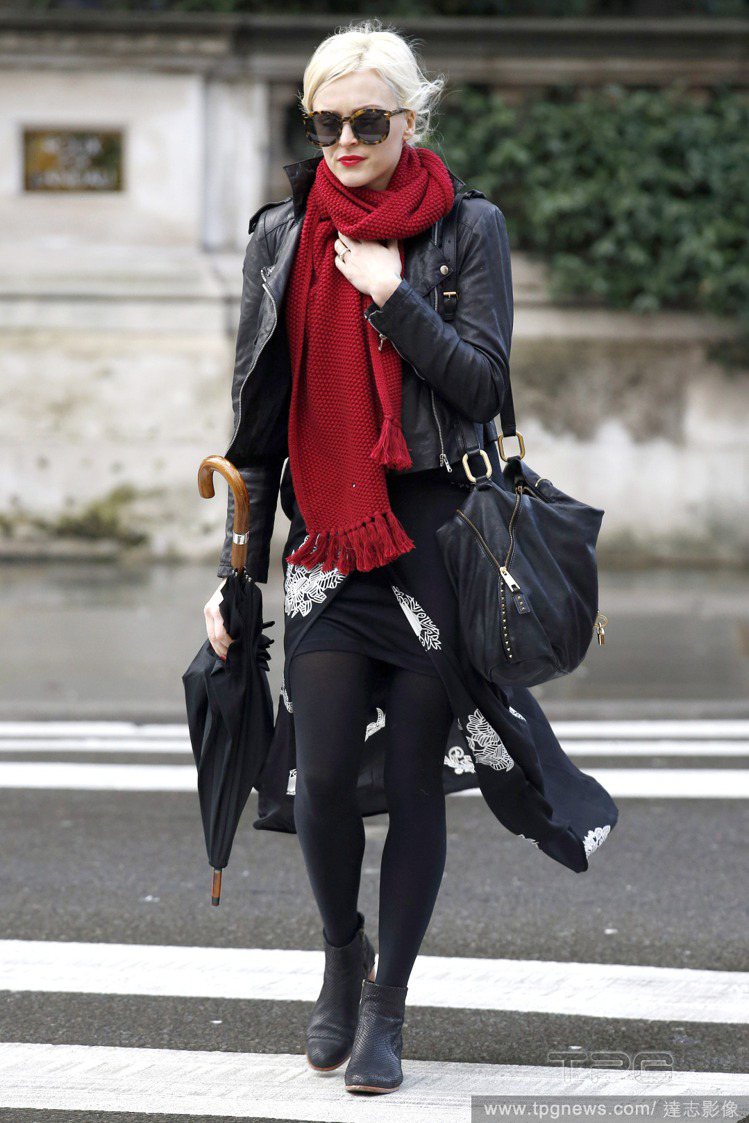 菲妮柯頓用紅圍巾搭配皮夾克與帶有中國風情的印花黑長裙，加深東方色彩時尚感。圖／達志影像