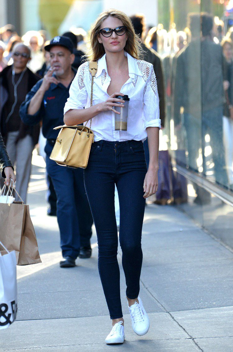 天使超模 Candice Swanepoel穿著白色 SUPERGA 2750 帆布鞋上街，簡單的襯衫搭配牛仔褲率性有型。圖／SUPERGA提供