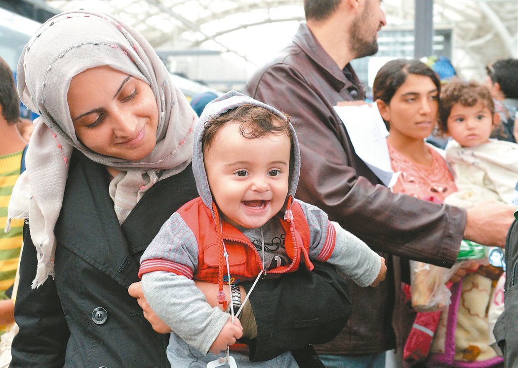 一對移民母子抵達奧地利薩爾茨堡車站後，難掩內心激動，笑容全掛在臉上。 美聯社