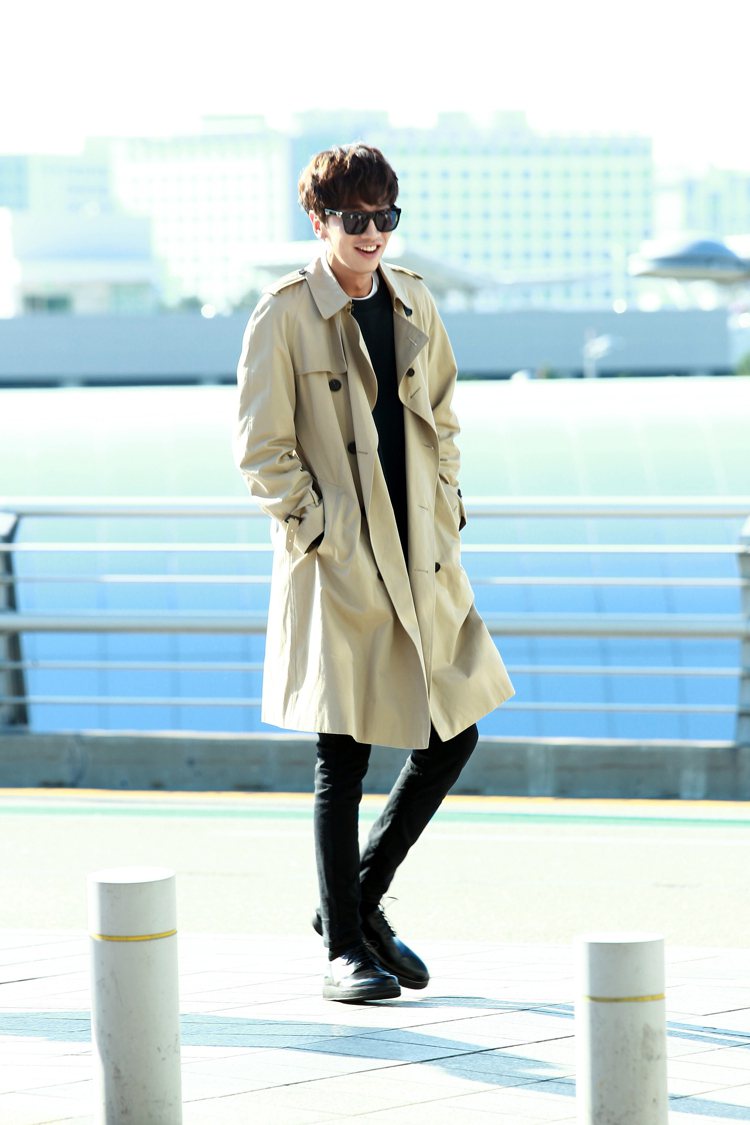 李光洙在仁川機場以風衣搭襯一身黑，清爽帥氣。圖／BURBERRY提供