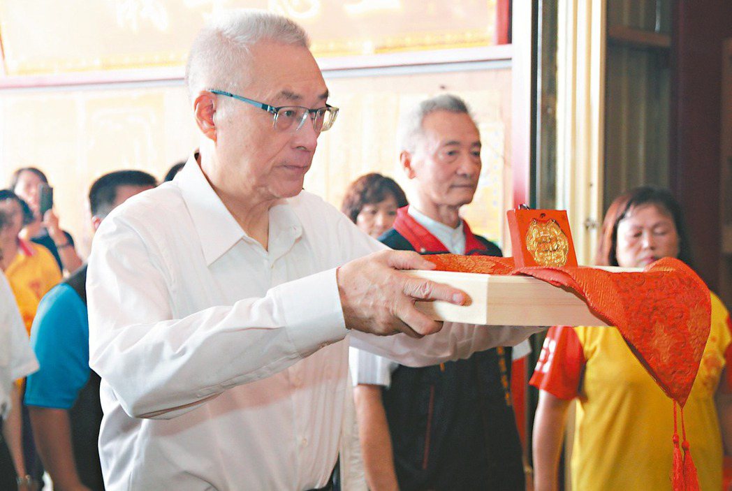 國民黨準主席吳敦義（左）昨到台中參拜六房媽會供奉的媽祖，並打一塊金牌還願。 記者...