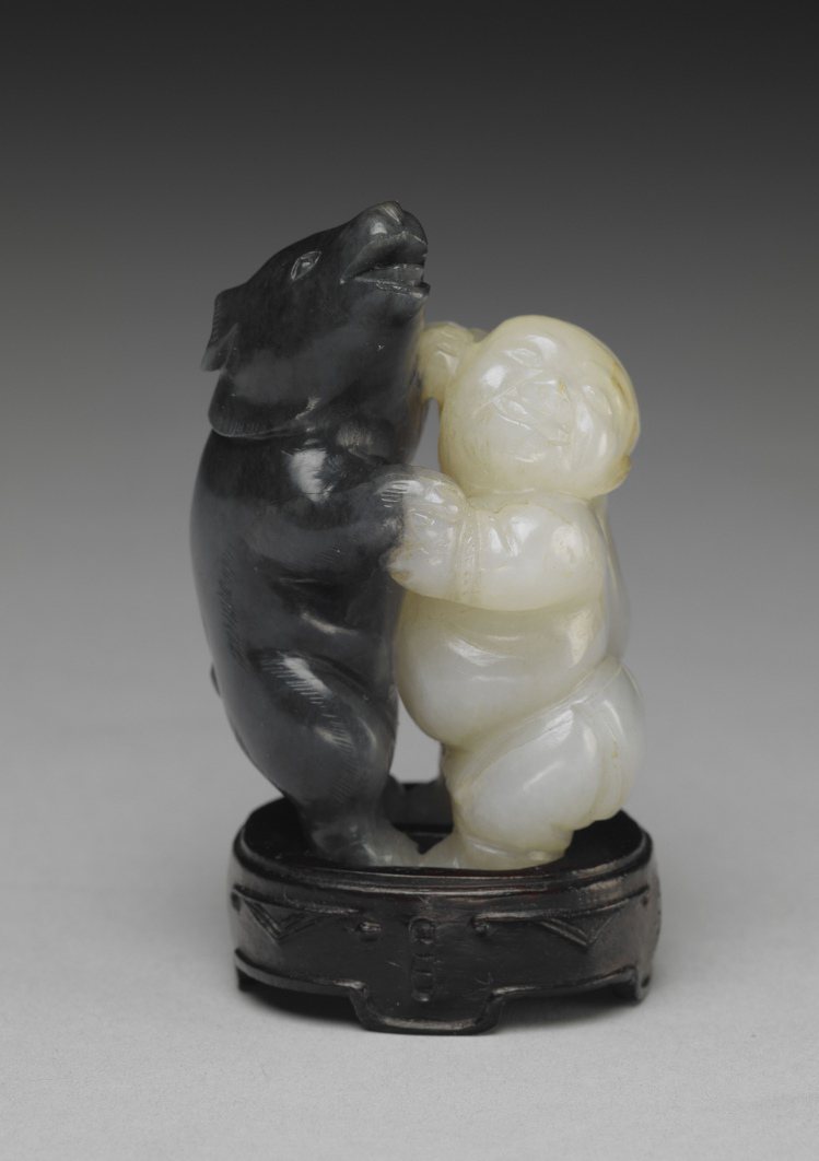 「玉人與熊」是清代工匠依照玉石材質自然顯現的黑白雙色，巧雕完成一人一熊玩「相撲」的姿態。圖／故宮提供