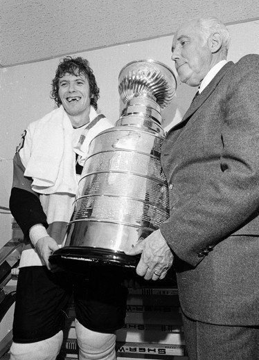 1974年費城飛人隊隊長克拉克舉起冠軍金杯的畫面，堪稱是冰球史上的經典。 圖／美聯社