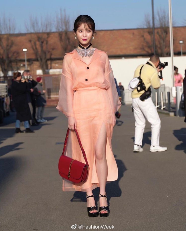 韓國女星IU穿著一襲粉紅色透膚裝翩然現身，粉嫩配色和輕薄材質讓她展現「滿滿仙氣」...