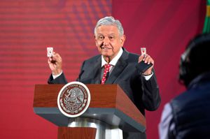 墨西哥總統羅培茲3月18日在記者會上展示防疫護身符。（路透）
