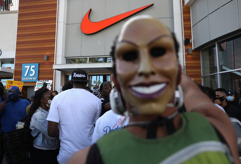 Nike在29日上傳黑底白字的短片為「黑人的命也是命」發聲，圖為抗議者在一間Nike店面外聚集。 路透