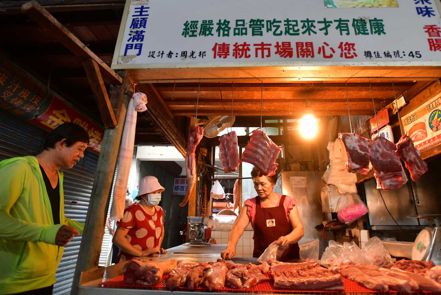 天剛亮，傳統市場肉攤擺上新鮮溫體豬肉，供民眾採買。「冰過的不好吃，」有溫度才有鮮度，台灣人吃下去的七成豬肉都來自於此。圖片來源：劉國泰攝