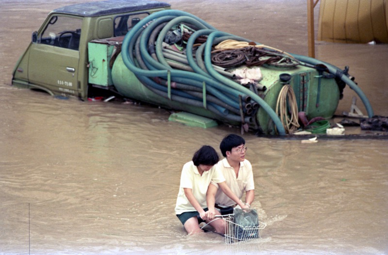 琳恩颱風過境，在台灣北部、東北部帶來驚人雨量，造成建國南、北路高架橋兩側道路積滿了汙水，民眾冒著危險涉水而過。圖／聯合報系資料照片