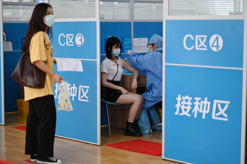 大陸民眾在廣州市天河體育中心新冠疫苗臨時接種點接種疫苗。（中新社）