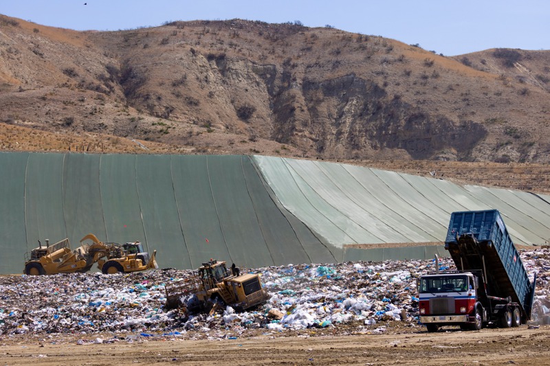 美國加州爾灣一個垃圾掩埋場的工作人員用重型機具搬運垃圾。路透
