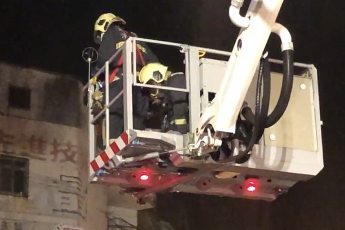 彰化喬友大樓大火，消防局動用雲梯車將受困者救下來，消防人員為受困者施做CPR急救。圖／聯合報系資料照片