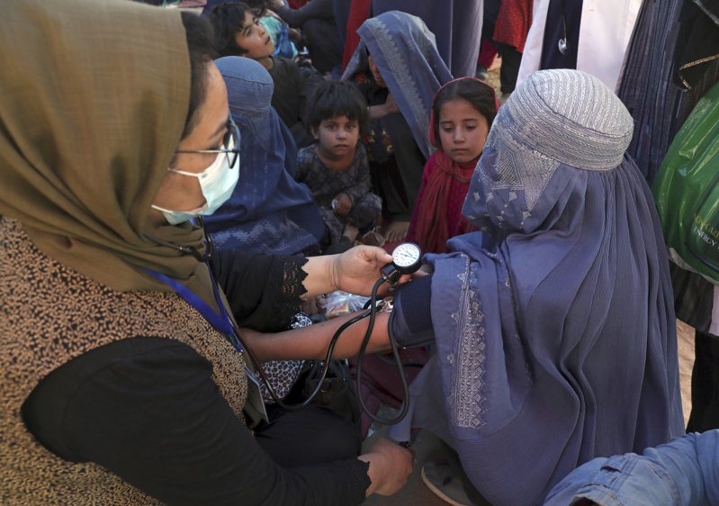 阿富汗半数以上人口分佈在都市之外的乡村，村落女性仍多数没有受教育、过着布卡蒙面的生活。图为8月10日在喀布尔北部，一名用布卡蒙面的妇女正在量血压情形。美联社资料照(photo:UDN)