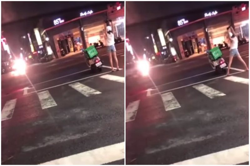 一名女外送員在停等紅綠燈時，在馬路上做起健康操，影片曝光後，引發網友熱議。圖／翻攝自爆料公社二社