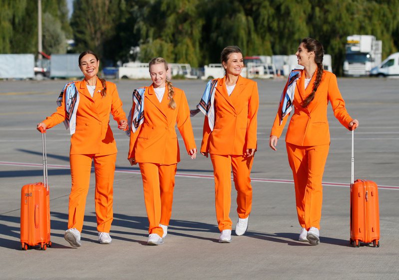 全新的SkyUp女性空服员制服包括耐吉（NIKE）白色运动鞋，以及乌克兰品牌制造的宽松橙色西装外套、长裤和丝巾。 路透社(photo:UDN)