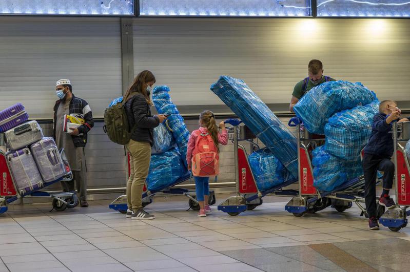 南非約翰尼斯堡奧利弗．坦博國際機場旅客26日正排隊準備搭乘飛機離境。美聯社