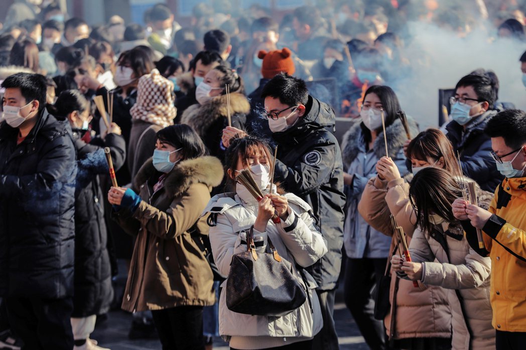 圖為2022年1月1日，北京雍和宮喇嘛廟，大批帶著口罩的市民元旦參拜。 圖／歐新...