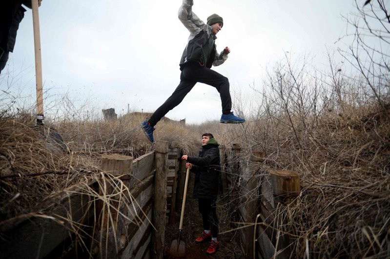 烏克蘭東部青少年11日替官兵挖壕溝因應俄國的可能入侵。法新社
