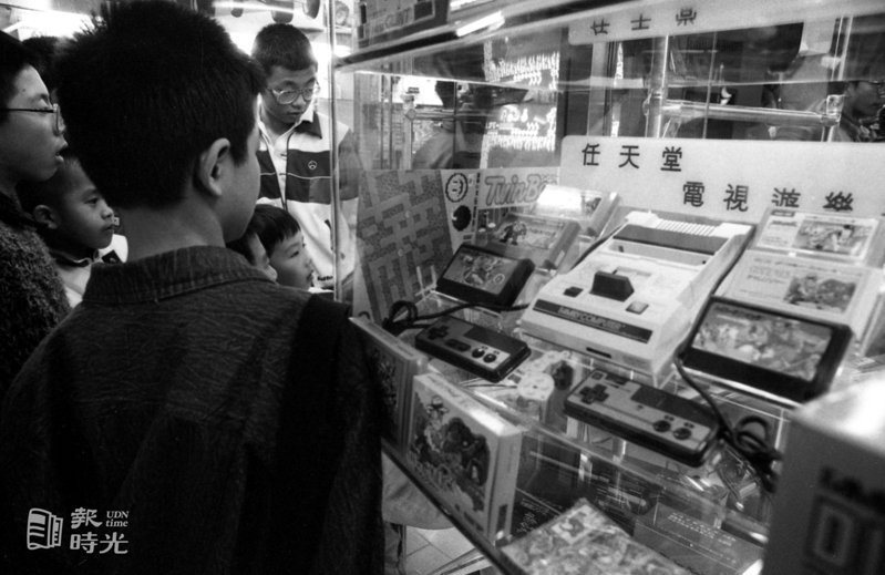 公共場所禁止電動玩具店營業後，由於青少年對其喜愛程度仍不減，新型專供電玩的電視遊樂器正走入家庭，意外造成新商機，圖為目前最熱銷的日本任天堂卡帶式遊戲機。　日期：1986/3/22．攝影：本報記者．來源：聯合報