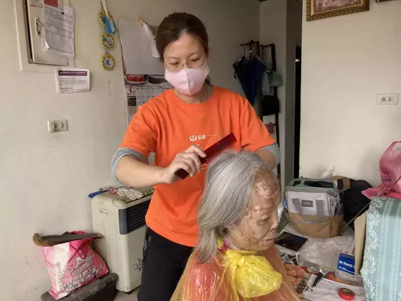 照顧秘書張晉僖為美櫻阿姨修剪頭髮，讓對方相當感動。
 圖／張睿廷 攝影