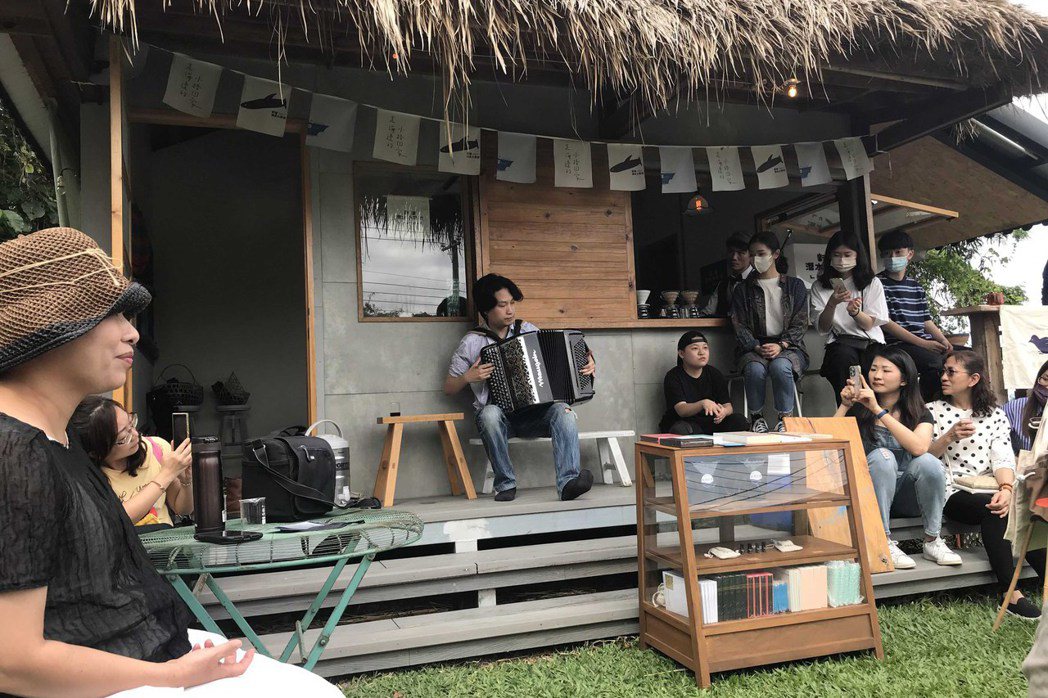 「小湊歌謠祭」在新港潛水小學校前方草地上安排手風琴家蔡偉靖的即興演奏，以及「古殿樂藏」殿主播放留聲機蟲膠唱片的「草地音樂派對」。 圖／作者自攝