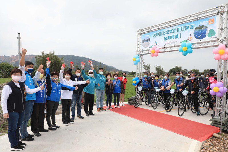 台中市長盧秀燕（左五）主持大甲北堤東路自行車道啟用典禮，形容這是稻田中的自行車。圖/觀旅局提供
