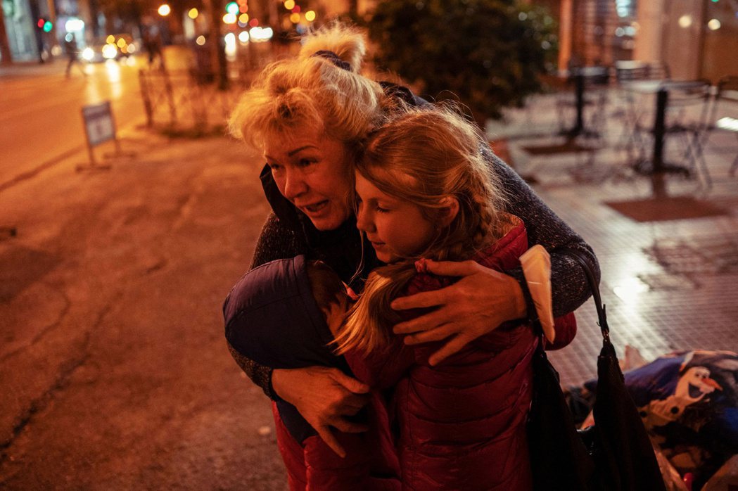 3月6日，逃難抵達雅典的烏克蘭母親激動抱著兩名孩子。 圖／法新社 