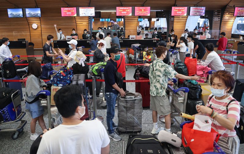 越南旅客在報到櫃臺前排隊，等待辦理報到手續。記者黃仲明／攝影