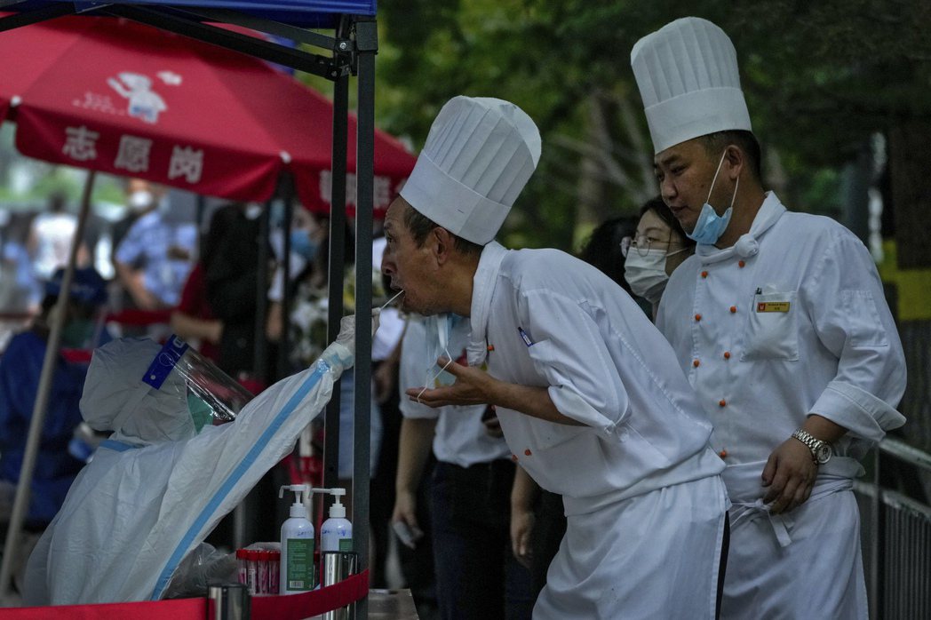 圖為北京民眾排隊做核酸檢測。 圖／美聯社