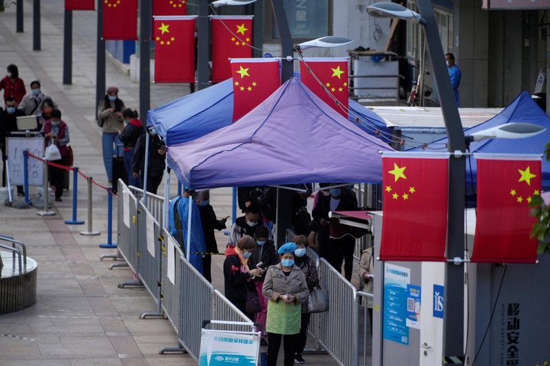 圖為日前上海市民排隊接受核酸採樣。路透