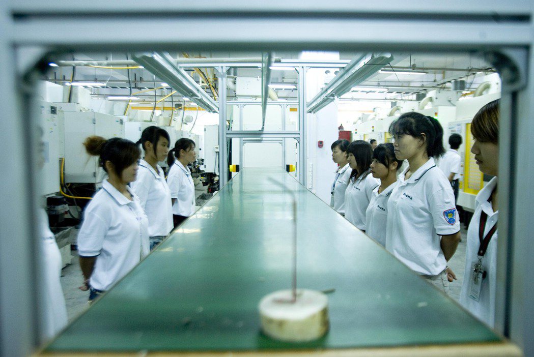 圖為2010年8月2日，河南鄭州富士康員工在生產線上工作。 圖／中新社