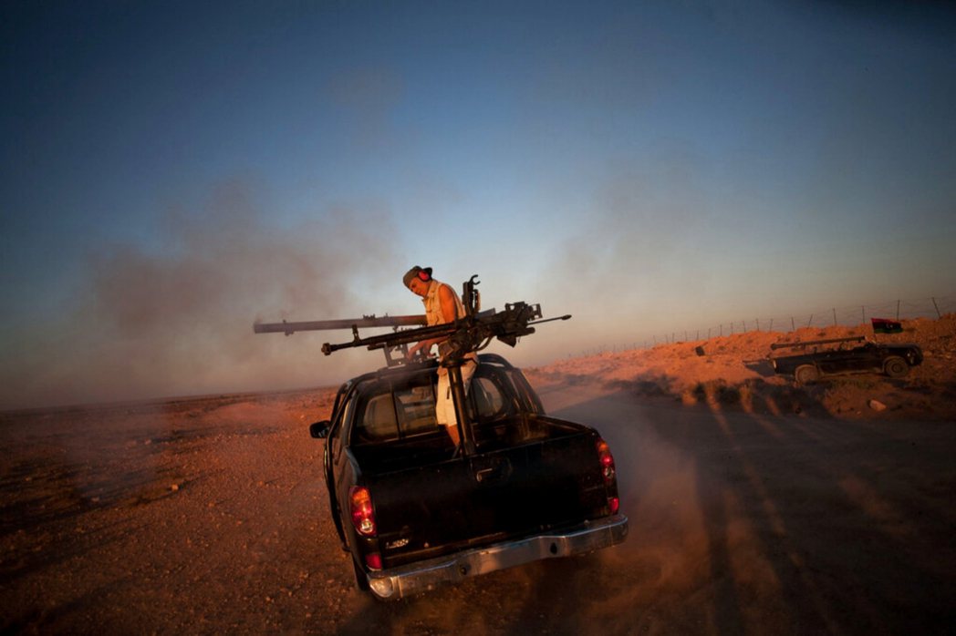 一名利比亞民兵測試武器。 圖／美聯社　